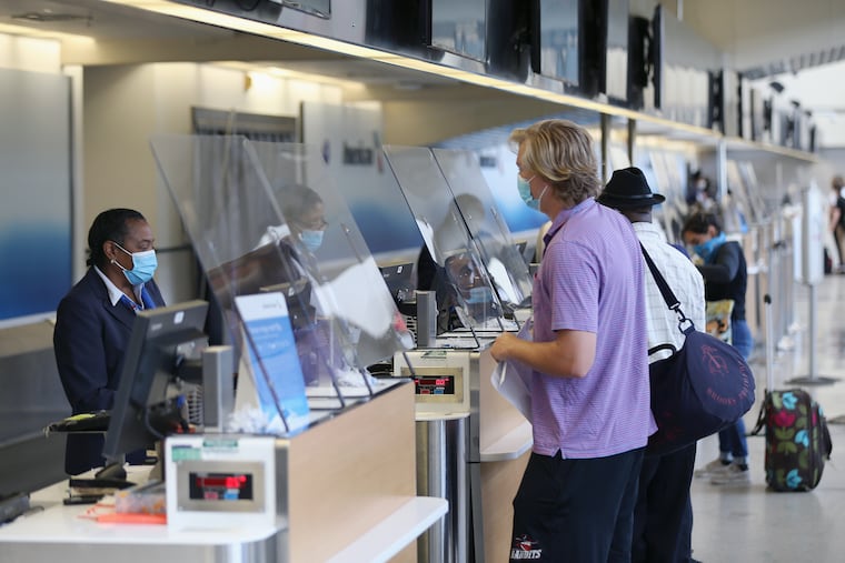 A passenger talking to an American Airlines worker at ticketing inside Philadelphia International Airport in late June.