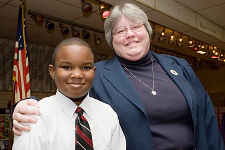 Second-grader David Atkins and school principal Sister Cheryl Ann Hillig at Saint Martin de Porres school in Germantown. (Jessica Griffin / Staff Photographer)
