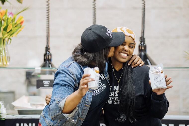 Charisse McGill of Lokal Artisan Foods smooches the cheek of her daughter, Madison.
