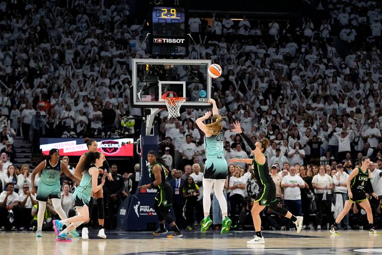 Sabrina Ionescu (center) launches her game-winning three-pointer for the New York Liberty.
