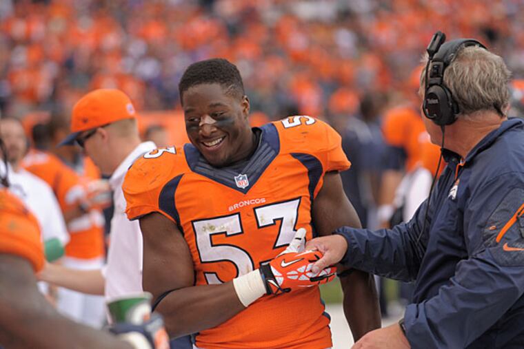 Broncos linebacker Steven Johnson (53) is congratulated by teammates after blocking a punt and scoring a touchdown against the Philadelphia Eagles during an NFL football game, Sunday, Sept. 29, 2013, in Denver. (Jack Dempsey/AP file)
