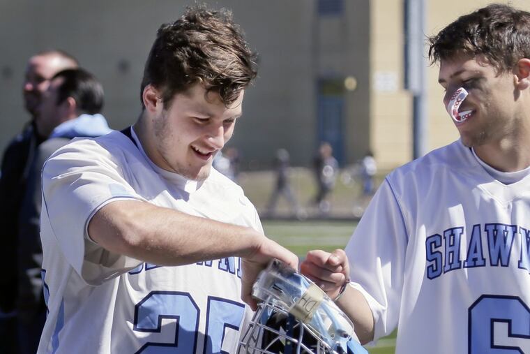 Shawnee HS lacrosse goalkeeper Dan Falzone (left) gets a fistpump from temmate Tom Shinske after Shawnee's victory over Haddonfield on March 31, 2018.