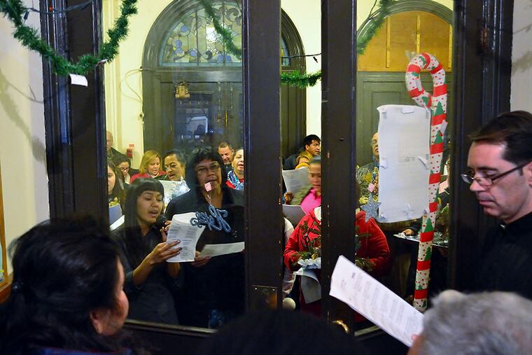 West Kensington Ministry members reenact the Latin American Christmas tradition "posada" with a twist Sunday, December 14, 2014. Because parishioner Angela Navarro, an undocumented alien, can’t leave the church, they skipped walking through the neighborhood. C.F. SANCHEZ / Staff Photographer