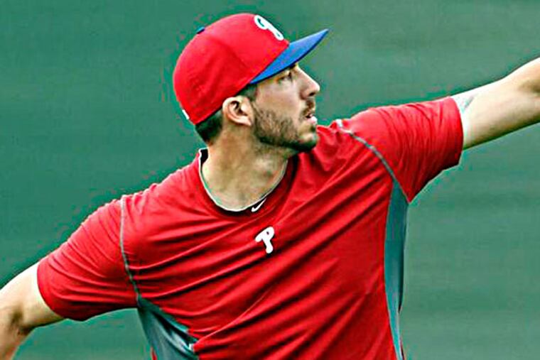 Phillippe Aumont winds-up with the baseball during Spring Training workouts in Clearwater, FL on Tuesday, February 12, 2013. (Yong Kim/Staff Photographer)