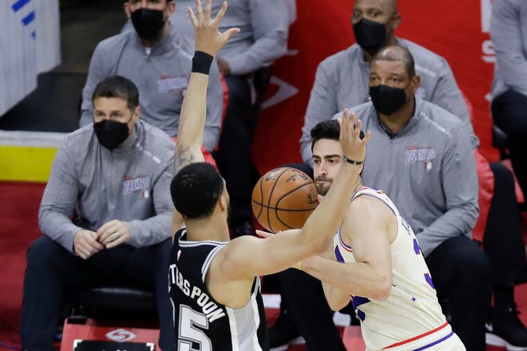 Sixers guard Furkan Korkmaz holding the basketball against San Antonio Spurs guard Quinndary Weatherspoon on Sunday.