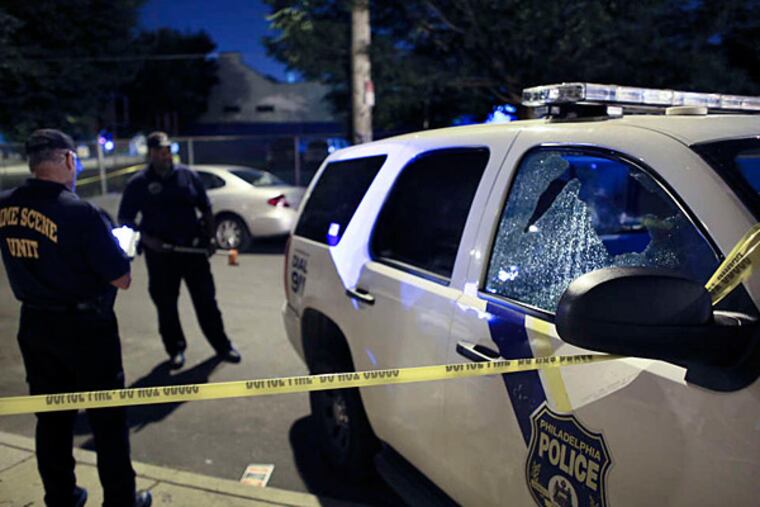 Shots rang out late Saturday near Franklin Street and Montgomery Avenue, striking this police SUV and Jameer Haynesworth, 16.