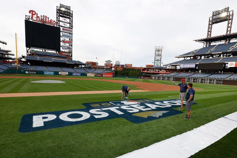 The Phillies grounds crew readies the playing field for postseason play at Citizens Bank Park on Wednesday.