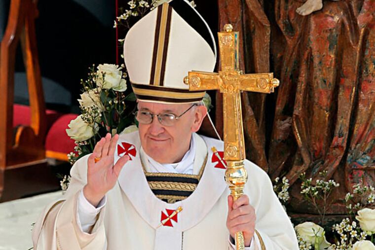 Pope Francis waves as he holds the pastoral staff in St. Peter's Square at the Vatican. Pope Francis has urged princes, presidents, sheikhs and thousands of ordinary people gathered for his installation Mass to protect God's creation, the weakest and the poorest of the world. DMITRY LOVETSKY / Associated Press