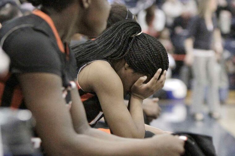 With the outcome certain , Woodrow Wilson's Lyayshia Stevens holds her head in her hands after coming out of the game in the fourth quarter. ELIZABETH ROBERTSON / Staff Photographer
