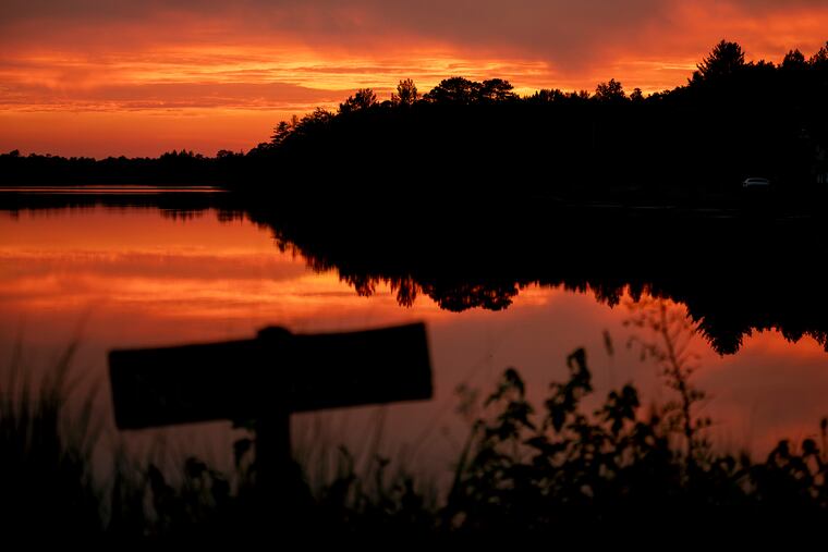 Smoke from the Wharton State Forest wildfire transforms the sky over Atsion Lake in Shamong at sunset June 21, 2022.