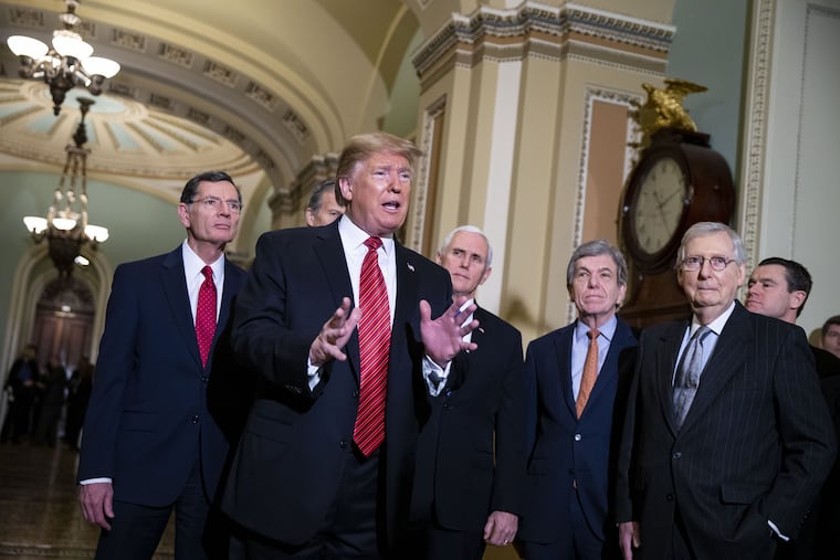 President Donald Trump (center) speaks to reporters after a Senate Republicans policy luncheon earlier this month.
