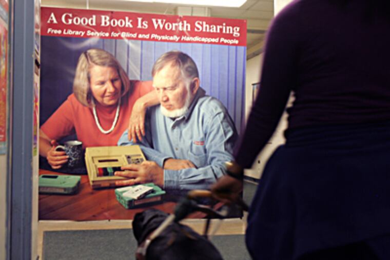 Nana Osei, 23, walks with her guide dog Nevan through Philadelphia's Library for the Blind, in December 2010. DAVID SWANSON / Staff Photographer
