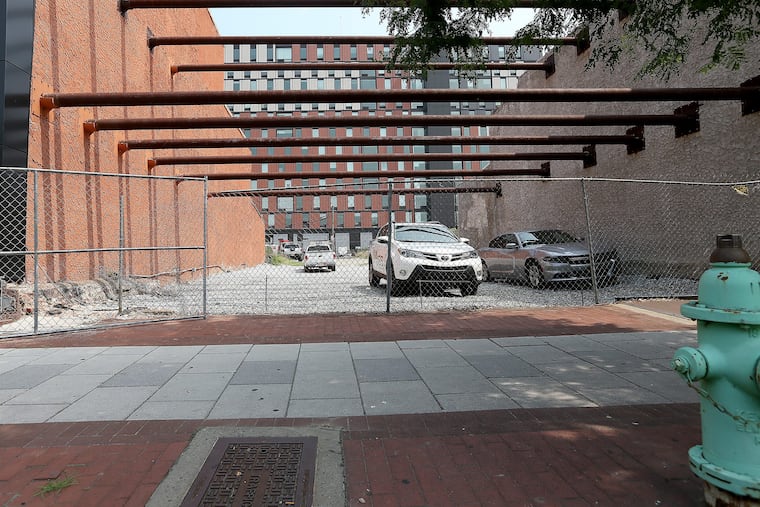 A cleared lot at 317 Market Street in Camden, NJ that Damon Pennington said will be a pop-up beer garden by August. On July 3, 2018 vehicles park on the lot. DAVID MAIALETTI / Staff Photographer