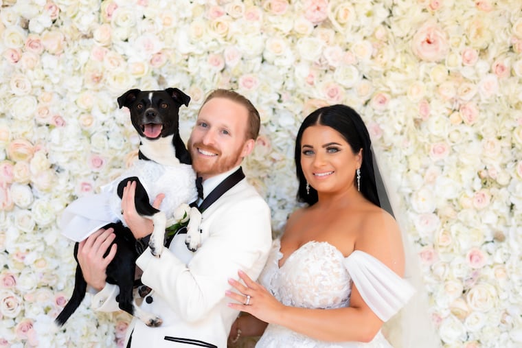 Newlyweds Josh and Sarah, with fur baby Daisy.
