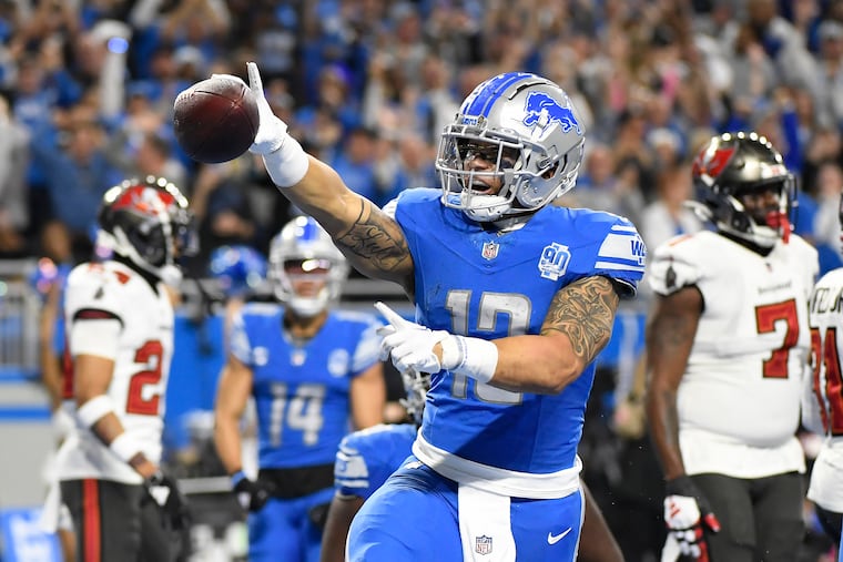 Lions running back Craig Reynolds celebrates after scoring a touchdown against the Tampa Bay Buccaneers during Detroit's divisional playoff victory on Sunday.