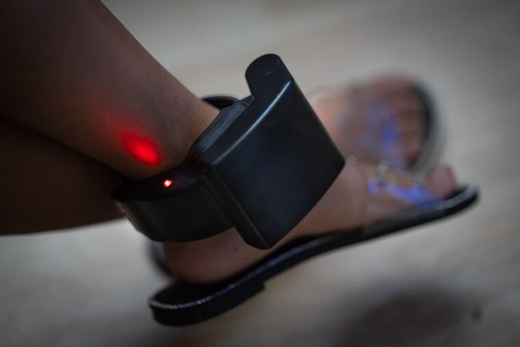 Paola, a mother of two who said she fled Honduras four years ago because of an abusive husband, wears a GPS-enabled ankle monitor in Virginia.