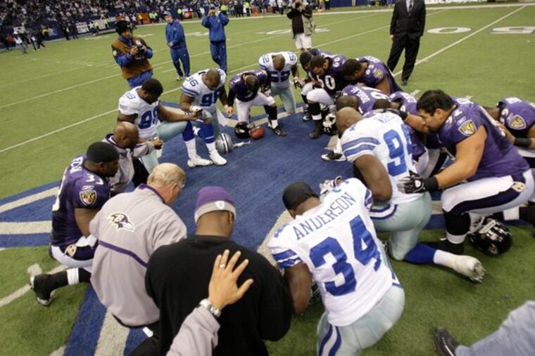 Cowboys players and coaches gather at midfield for a prayer after the final game at Texas Stadium. Dallas bid farewell by losing to Baltimore with a late meltdown.