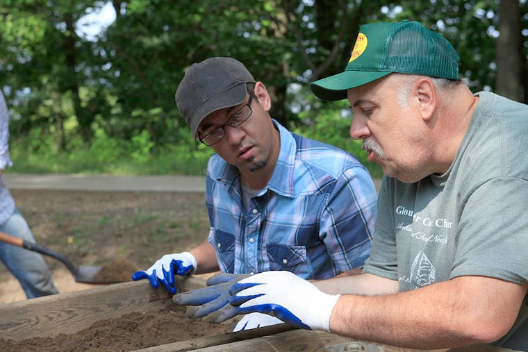 Jim Mosley (blue shirt), a social studies teacher from Upper Pittsgrove School, sifts for artifacts with help from Guy DiGiugno, a volunteer with the Archaeology Society of New Jersey.