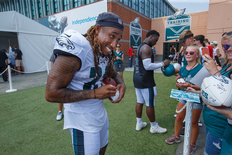 Eagles cornerback Ronald Darby, left, signs autographs at Eagles training camp. He practiced Sunday for the second straight day and said he felt "great.''