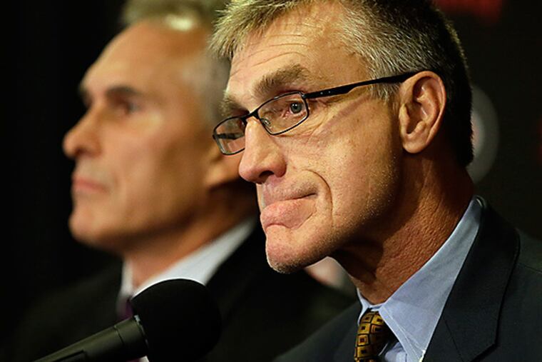 Flyers general manager Paul Holmgren (right) addresses the media upon introducing Craig Berube (left) as the team's new head coach. (Matt Slocum/AP)