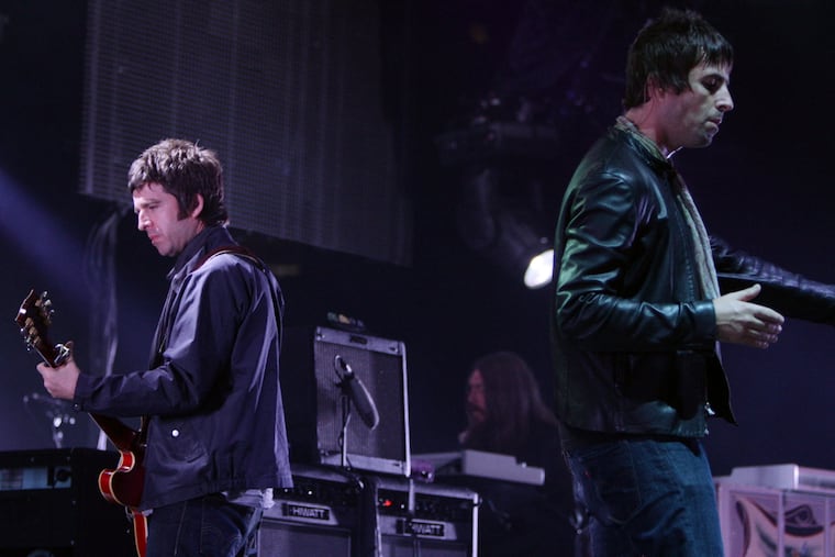 Noel, left, and Liam Gallagher, of Oasis, perform during the start of their Canadian tour in Vancouver, B.C., on Aug. 27, 2008.