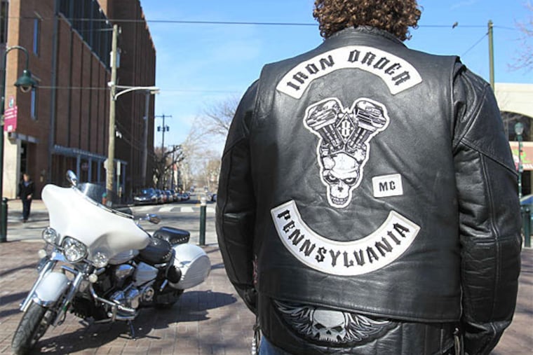 Eric Sauers shows off his club jacket on Locust Walk at Penn, where he is a Web designer. (Charles Fox/Staff)