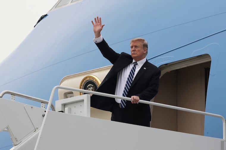 President Donald Trump waves as he boards Air Force One after a summit with North Korean leader Kim Jong Un, Thursday, Feb. 28, 2019, in Hanoi.