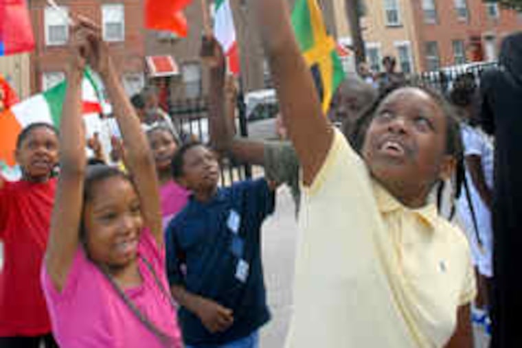 Opening Philadelphia's summer-school program are Mwujiza Kahey (left), 9, and Markeisha Oliver, 11, at Chester Arthur School. Almost 58,000 are registered. Story, another photo, B5.