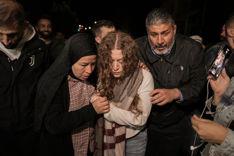 Palestinian activist Ahed Tamimi, center, is supported by her mother after she was released from prison by Israel, in the West Bank town of Ramallah early Thursday.