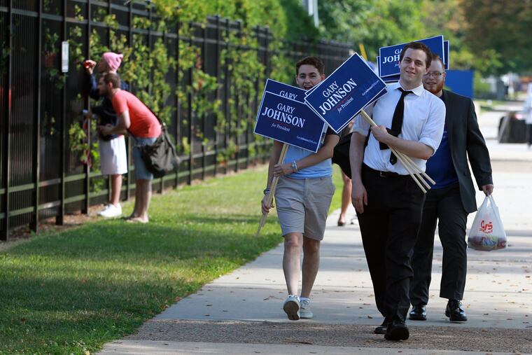 Eagles training camp opens at the NovaCare Complex on the same day the Democratic National Convention begins and protesters fill up FDR Park. Gary Johnson supporters make their way along South Broad as others try to sneak a peak at the Eagles practice July 25, 2016.