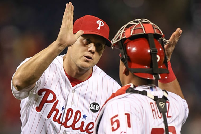 Jonathan Papelbon celebrates with catcher Carlos Ruiz after beating the Marlins. (Steven M. Falk/Staff Photographer)