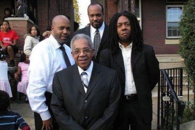 Mr. Poindexter (front) stands with his sons, from left, Darryl, Duane, and Derek.
