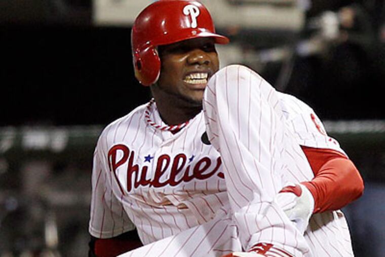 Ryan Howard clutches his ankle after rupturing his Achilles. (Yong Kim/Staff Photographer)