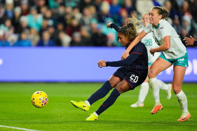 Catarina Macario (left) fights past New Zealand's Elizabeth Anton (right) to score a goal during the second half.