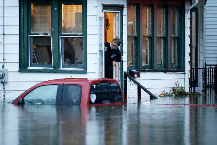 A man in a home on High St. waits for rescuers to come back for him after overnight thunderstorms flooded much of Westville on June 20, 2019.