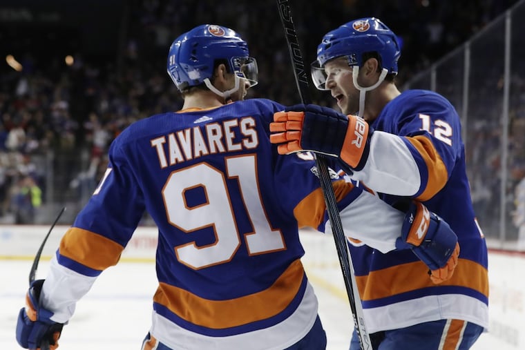 New York Islanders right wing Josh Bailey (12) celebrates with teammate John Tavares (91) after scoring the winning goal in overtime Wednesday.