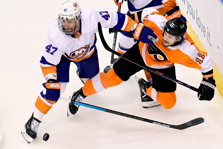 Travis Konecny is knocked off the puck by Leo Komorov during the second period of Monday night's series opener.