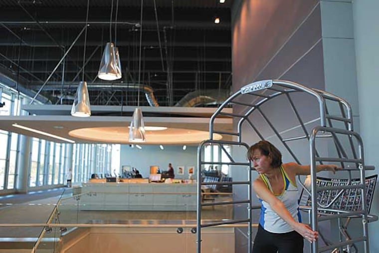 Beth Van Fossen stretches before her workout. Virtua has a new Center for HealthFitness in Moorestown. 12/06/12. ( Michael S. Wirtz / Staff Photographer )