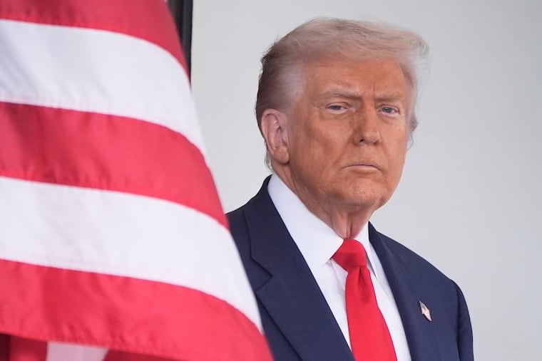President Donald Trump waits to greet Argentina's President Javier Milei, as he arrives at the White House, Tuesday, Oct. 14, 2025, in Washington.