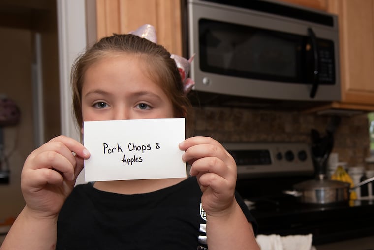 Grace Edwards, 6, holds up her dinner note cards at her home in Springfield, Delaware County.