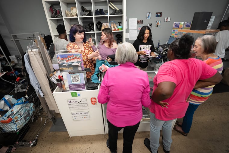 Clients and volunteers at The Wardrobe, a Philadelphia organization dedicated to connecting people with clothing, during an event held Sept. 24 where people could pick out garments and accessories for free.