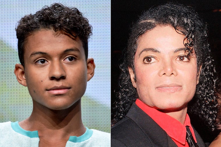 Jaafar Jackson appears during the "Living with The Jacksons" panel at the Reelz Channel 2014 Summer TCA in Beverly Hills, Calif., in 2014, left, and Michael Jackson appears at the American Cinema Award gala in Beverly Hills, Calif., in 1987.