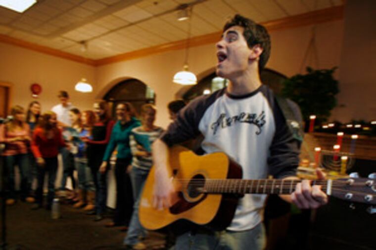 Muhlenberg College student Stephen Brickman sings during the school's Hanukkah celebration. The small Lutheran college in Allentown has the 10th-largest percentage of Jews among U.S. colleges.
