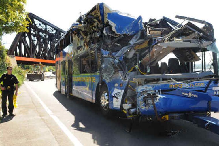 The wreckage of a Megabus sits near the railroad bridge it struck about 2:30 a.m. Saturday in Onondaga County, N.Y. A Temple student and a N.J. teen were among the four people killed.