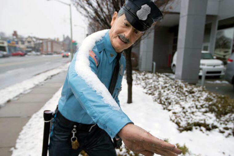 A statue of a policeman on the sidewalk Saturday, Jan. 24, 2015, in Ardmore seems to measure the amount of snow that fell.