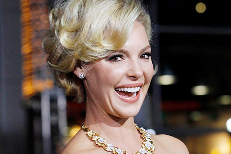 Actress Katherine Heigl poses at the premiere of "New Year's Eve" in Hollywood, California in this December 5, 2011 file photo. Actress Katherine Heigl has filed a $6 million civil lawsuit against New York pharmacy Duane Reade for using her name and an unauthorized paparazzi photograph of her in its commercial advertising. (Reuters/Mario Anzuoni/Files)