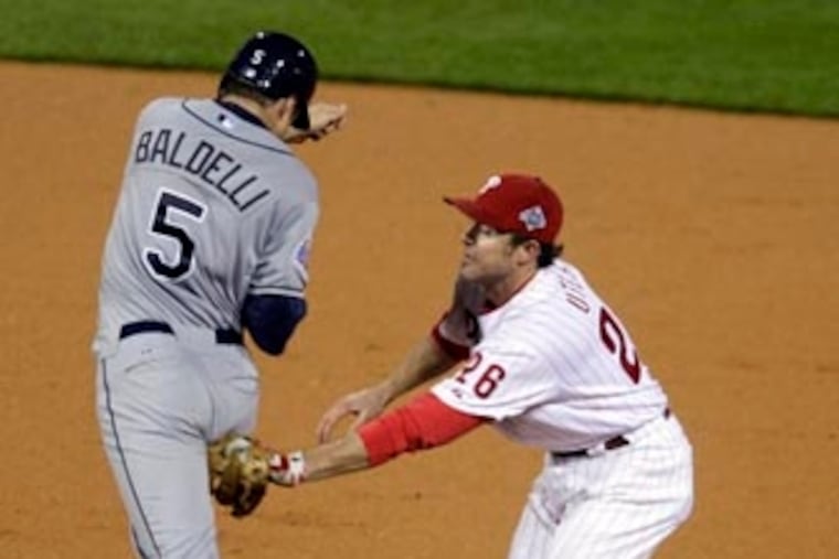 Chase Utley tags out Rocco Baldelli and then throws to first for a double play in the fifth inning. ( David Maialetti / Staff Photographer ) (The Philadelphia Inquirer and Daily News) The Philadelphia Phillies faced the Tampa Bay Rays in game five of the World Series at Citizens Bank Park on Monday, October 27, 2008