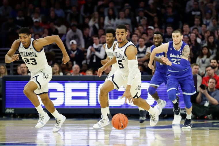 Phil Booth leads a fast-break with teammate Jermain Samuels (left) against Seton Hall in January.