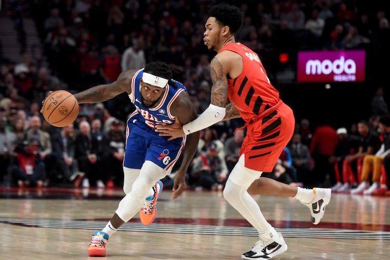 Sixers guard Patrick Beverley dribbles past Trail Blazers guard Anfernee Simons on Monday night.