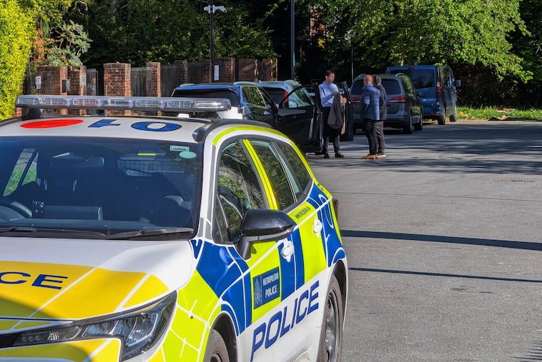 Police officers patrol at a cordon near Kenton United Synagogue in Harrow, a suburb of London, on Sunday.